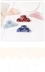 Detailed close-up of large marble-patterned shark hair clips in five assorted colors