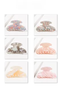 Six assorted hair claws featuring tortoiseshell marble and glitter floral patterns