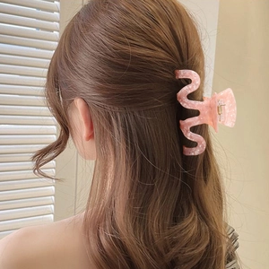 Pink marble texture wave hair claw clip for women shown in a half-up hairstyle