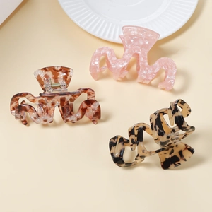 Three-piece hair claw clip set in pink marble, tortoiseshell, and leopard print patterns