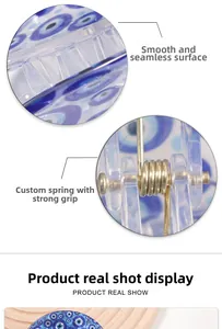 Detail of blue evil eye hair claw clip with strong golden spring and smooth finish