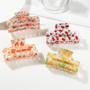 Set of four fruit pattern hair claws featuring pineapple, cherry, orange, and lemon designs