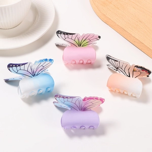 Elegant butterfly hair claw clips in four pastel colors on a clean aesthetic background