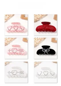 Detail display of pearl and rhinestone hair claws in multiple colors and floral designs