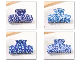 Detailed set of four evil eye pattern hair claws in blue and white glossy finishes