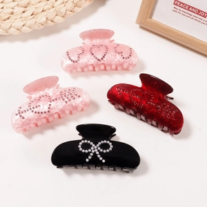 Set of 4 elegant hair claws featuring marble patterns with rhinestones and pearl bow details