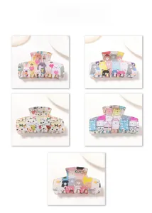 Detail view of five assorted acrylic hair claws featuring cute cartoon animal patterns