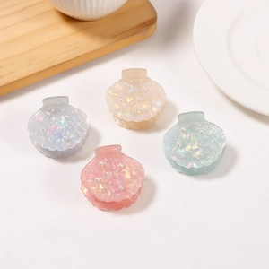 Elegant shell-shaped hair clips with pearls in white, pink, yellow, and green colors