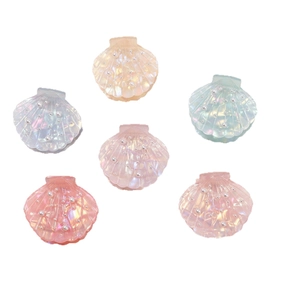 Elegant shell-shaped hair clips with pearl accents in shimmering iridescent colors