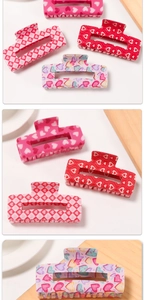 Detailed set of four acrylic hair claws featuring heart patterns and checkered designs