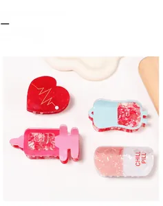 Detail view of PVC nurse theme hair claw clips including heart and pill designs