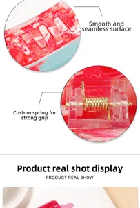 Detail of pink and white acetate hair claw clip showing smooth surface and strong metal spring