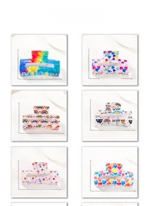 Detailed view of rainbow PVC hair claw clips in six vibrant pride patterns and dimensions