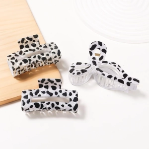 Three-piece hair claw set with black and white cow pattern in glossy resin finish