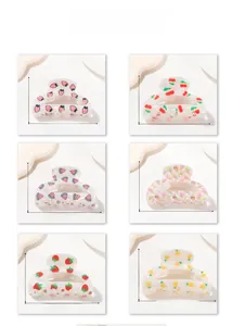 Detailed size chart of six fruit-patterned hair claws including strawberry and cherry