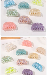 Close-up of semi-round acetate hair claws in macaron colors and marble textures