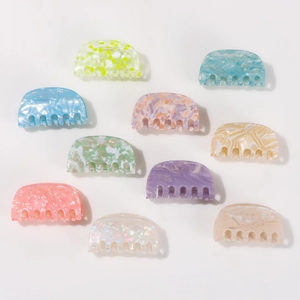Set of 10 colorful semi-round marble hair claws for women in various vibrant pastel shades