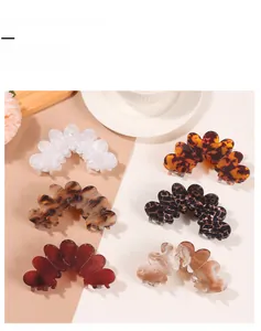 Detail view of six French floral petal hair claw clips in tortoise and marble patterns