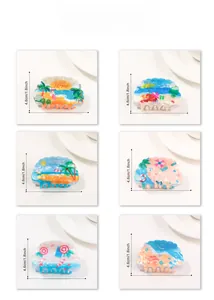 Detail view of six summer beach hair claws featuring coconut trees and shell designs