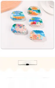 Detail view of summer beach hair claws with palm tree and surfboard resin patterns