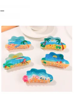 Detailed shot of Hello Summer print hair claw clip with palm tree and beach motifs