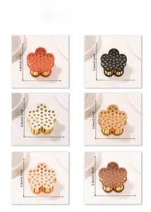 Detail view of floral hair claws with matte finish and gold stud accents in six colors