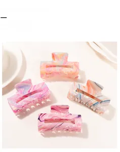 Detailed close-up of marble pattern rectangular hair claw clips in pastel macaron colors