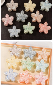Macro detail of acetate flower hair claw clips in assorted pastel macaron colors