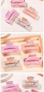 Detailed close-up of colorful marble pattern hair claw clips in a rectangular hollow design