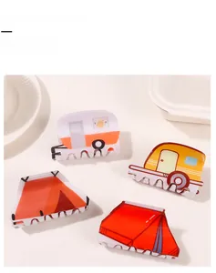 Detail of camping themed camper van and tent hair claw clips with glossy finish