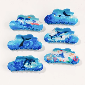 6-piece set of ocean-themed acetate hair claws featuring dolphins and sharks in blue tones