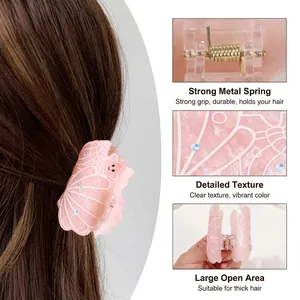 Pince à cheveux papillon rose avec texture coquillage et ressort métallique robuste