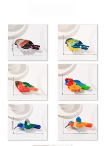 Detailed size guide for colorful acetate bird hair claws showing magpie and parrot designs