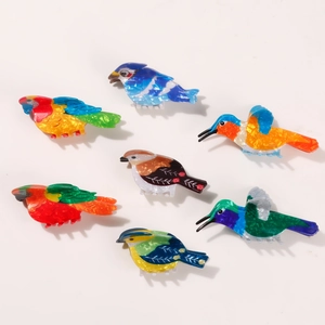Set of seven colorful bird-shaped hair claws with vibrant acetate shell patterns