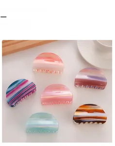 Detailed set of six semi-circular hair claw clips with sunset gradient marble patterns