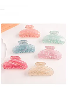 Close-up of six gradient hair claw clips in pastel macaron colors with marble texture