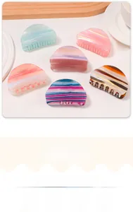 Detail view of sunset gradient acetate hair claws with premium marble texture and six colors