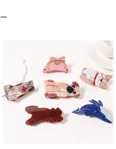 Flat lay of creative animal-shaped hair claw clips with premium marble texture patterns