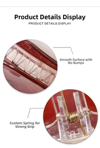 Detail of red hair claw clip showing smooth surface and durable golden metal spring