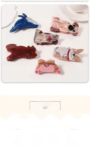 Detailed top view of animal-shaped hair claws made of marble-textured acetate material