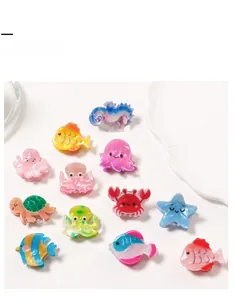 Close-up of colorful ocean animal hair claw clips with resin seahorse and starfish designs