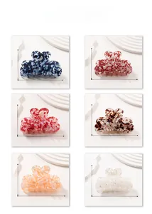 Detail view of large French acetate hair claws with various marble and floral textures