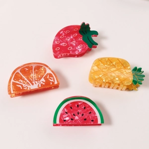 Set of four fruit-shaped hair claw clips including strawberry orange pineapple and watermelon