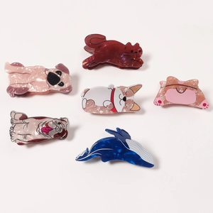 Creative acetate hair claws featuring cute animal shapes like dogs and whales on white