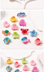 Close-up of glitter resin sea creature hair claws with fish and starfish shapes