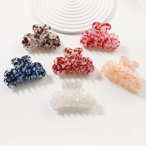 Set of six heart-shaped acetate hair claws with elegant marble and tortoiseshell patterns