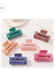 Detailed close-up of marble pattern hair claw clips in various elegant colors and textures