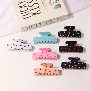 Set of 7 vintage polka dot hair claws in assorted colors with a glossy resin finish