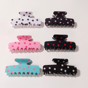 Set of six colorful polka dot hair claw clips for women with various stylish patterns