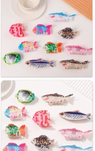 Collection of colorful ocean-themed hair claws featuring shark and tropical fish designs